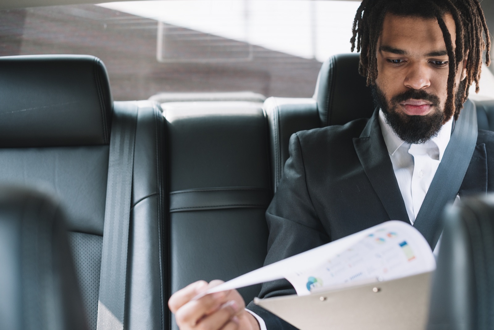 A rider reviewing documents in the back of a Zeno car